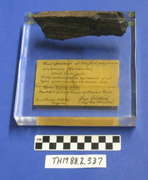 Rock specimen of the first geological era from Phantom Ranch Grand Canyon on a plastic base