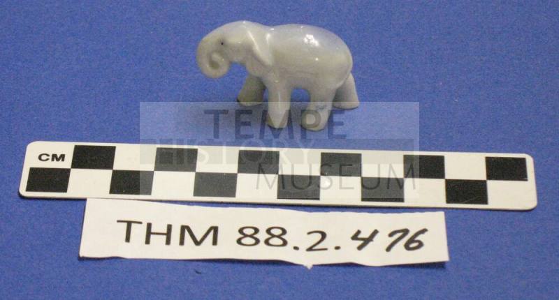 Blue grey elephant figurine with a curled trunk