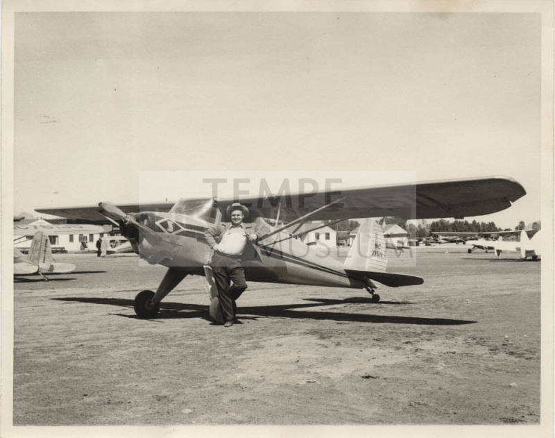 Photograph of Luther Finley with a small airplane