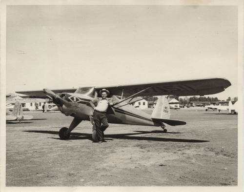 Photograph of Luther Finley with a small airplane