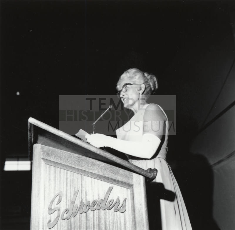 Woman Standing at a Podium