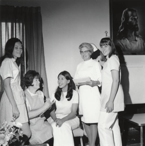 Two female nurses and three female "Candy Stripers"