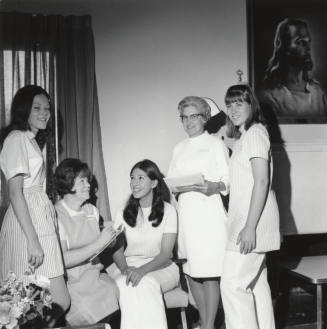 Two female nurses and three female "Candy Stripers"