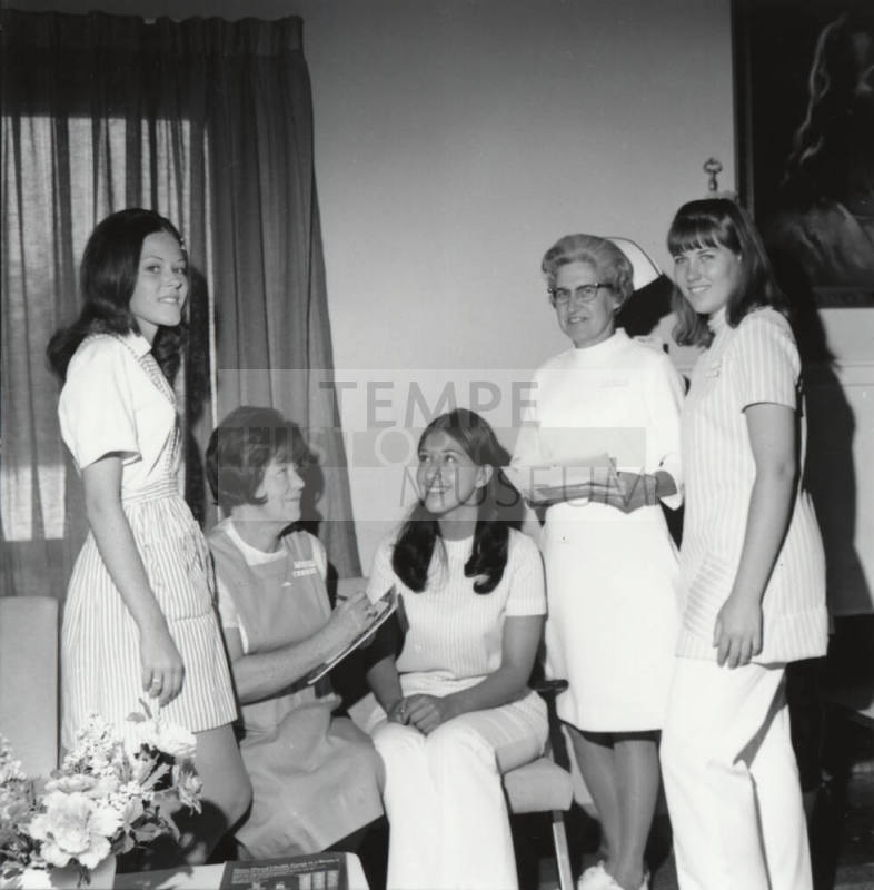 Two female nurses and three female "Candy Stripers"