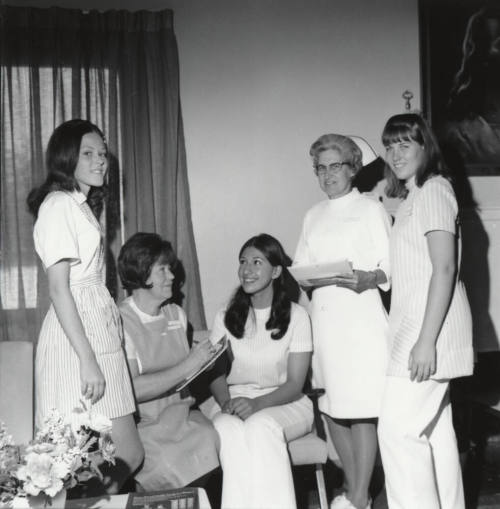 Two female nurses and three female "Candy Stripers"