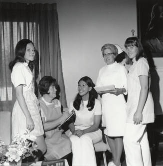 Two female nurses and three female "Candy Stripers"
