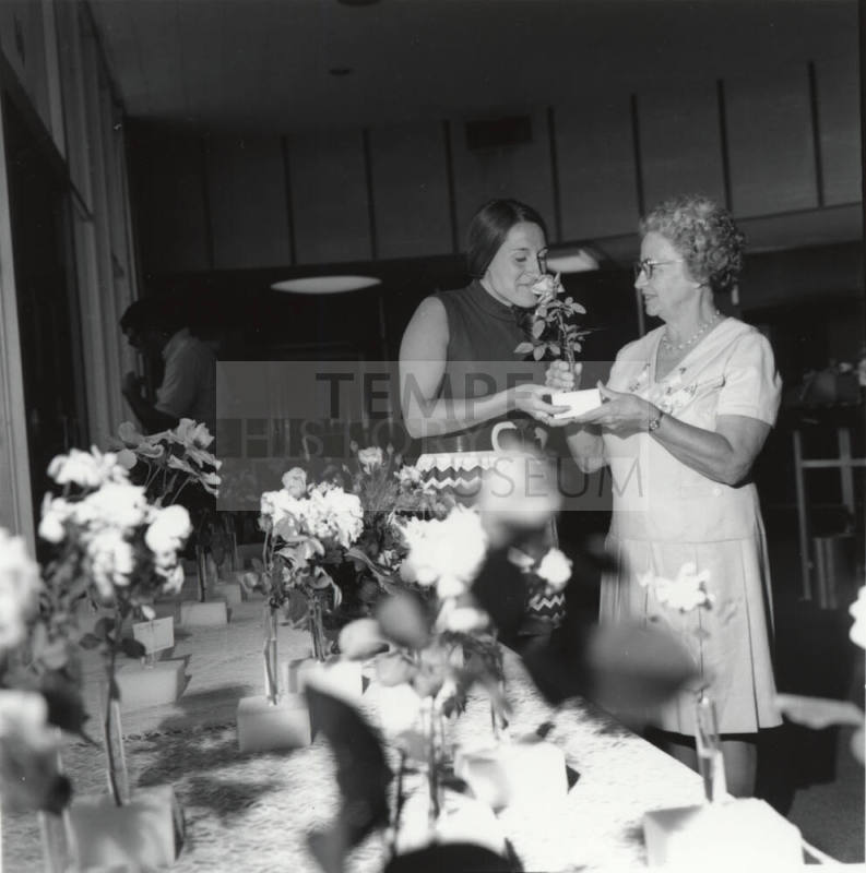 Two Women Admiring Roses