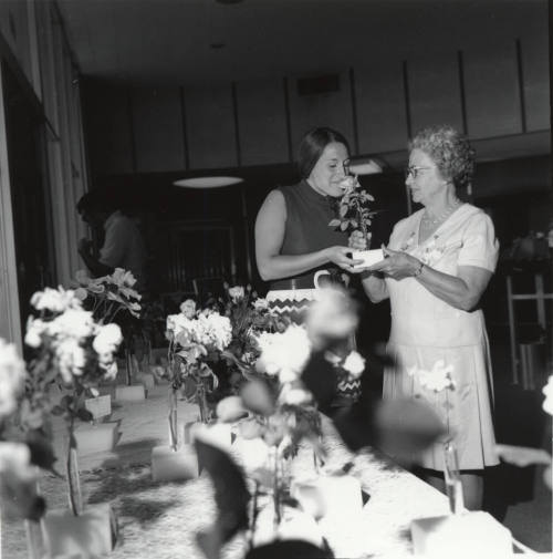 Two Women Admiring Roses