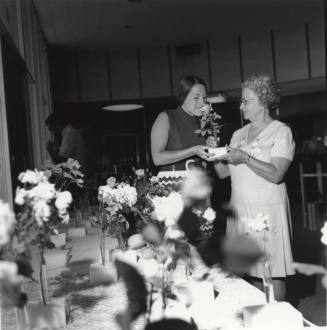 Two Women Admiring Roses