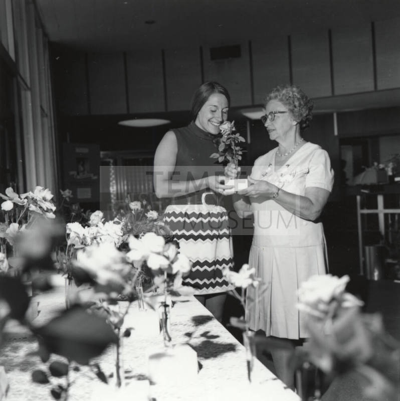 Two Women Admiring Roses