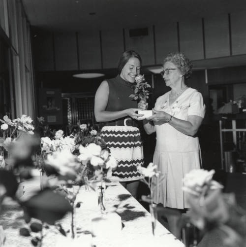 Two Women Admiring Roses