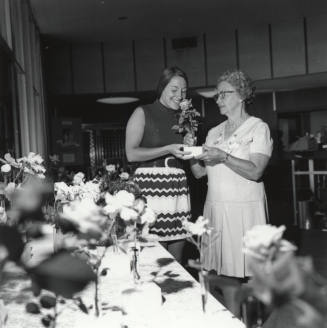 Two Women Admiring Roses