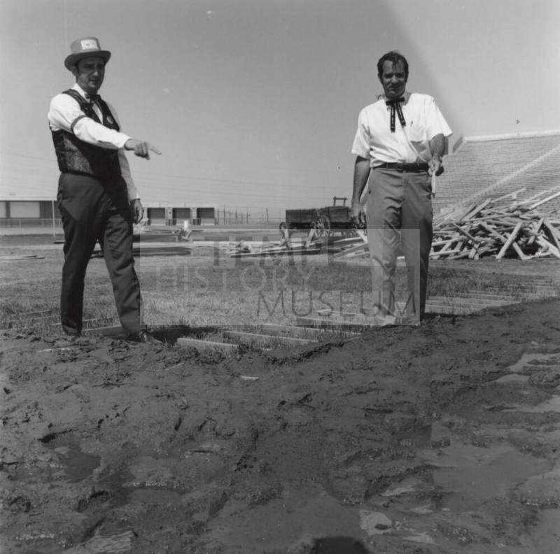 Men Standing In A Field - Bleachers