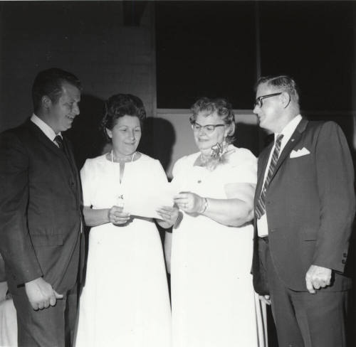 Two Men and Two Women Looking at a Paper (1 of 2)