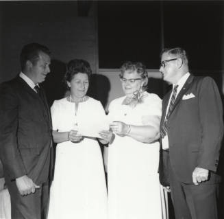 Two Men and Two Women Looking at a Paper (1 of 2)
