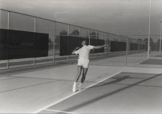 Unidentified Man Playing Tennis at Kiwanis Recreation Center in Kiwanis Park