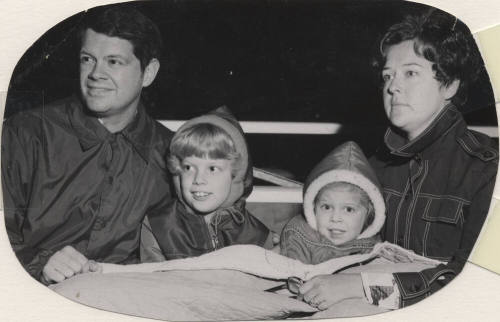 Family Watching Tree Lighting Ceremony at Community Grounds Near Library