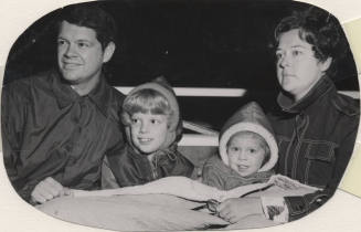 Family Watching Tree Lighting Ceremony at Community Grounds Near Library