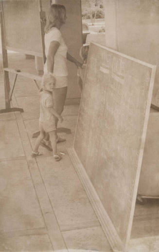 Woman and Children Pass Blackboard with "Closed Classes" Notification