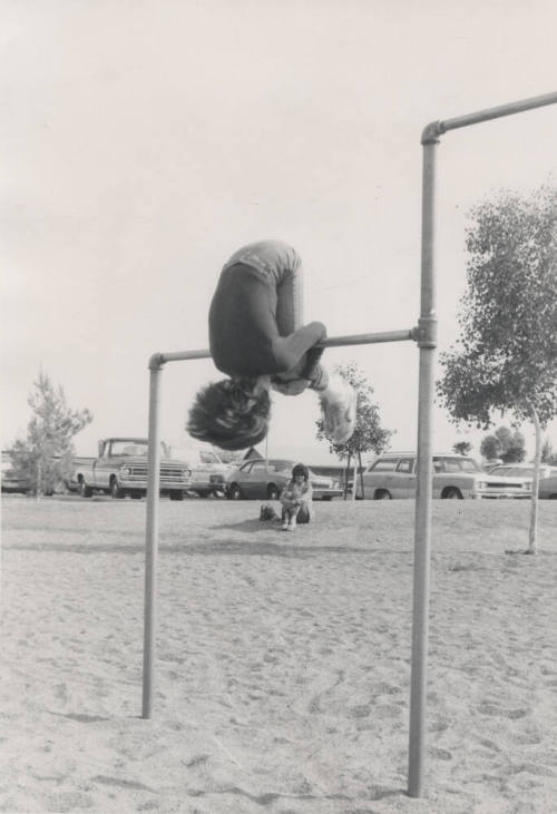 Child Performing Roll on Horizontal Bar