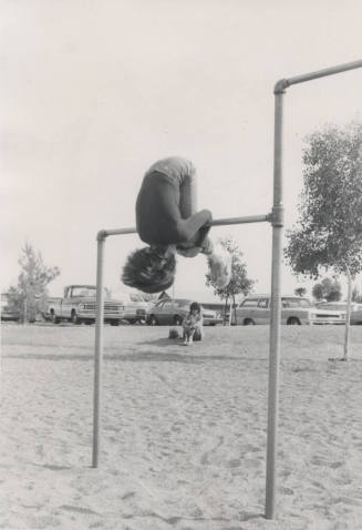 Child Performing Roll on Horizontal Bar