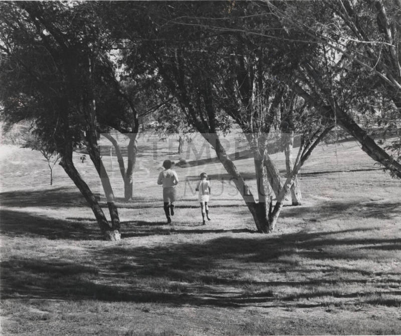 Two People Running in the Park - Newspaper Articles Included
