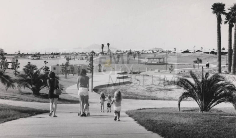 Women and Children Walking in Kiwanis Park - Horse Patrol in Background