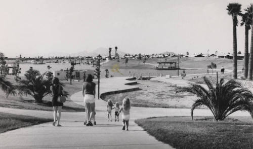 Women and Children Walking in Kiwanis Park - Horse Patrol in Background