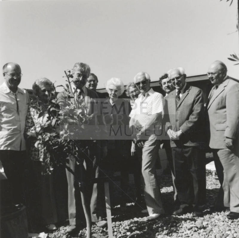 Group of people at a tree planting ceremony, A Lot of Caring