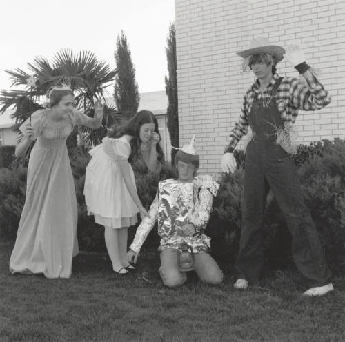 Four people dressed up for 'An Evening in Oz' at Tempe Stake Green and Gold Ball
