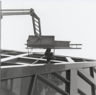Maintenance worker on elevated platform working on the Tempe City Hall facade