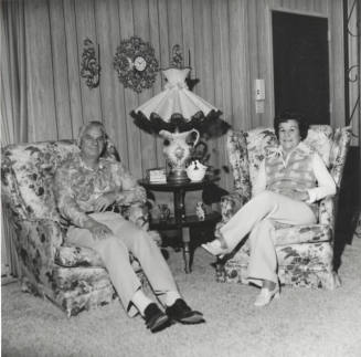 A Couple Sitting in Two Armchairs