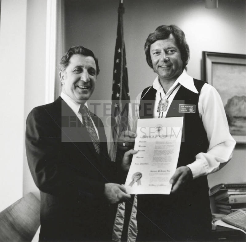 Mayor Bill LoPiano presents a "Harvey McKemy Day in Tempe" proclamation to Tempe Diablos president, Don Robinson.