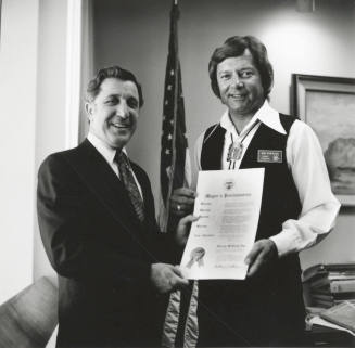 Mayor Bill LoPiano presents a "Harvey McKemy Day in Tempe" proclamation to Tempe Diablos president, Don Robinson.