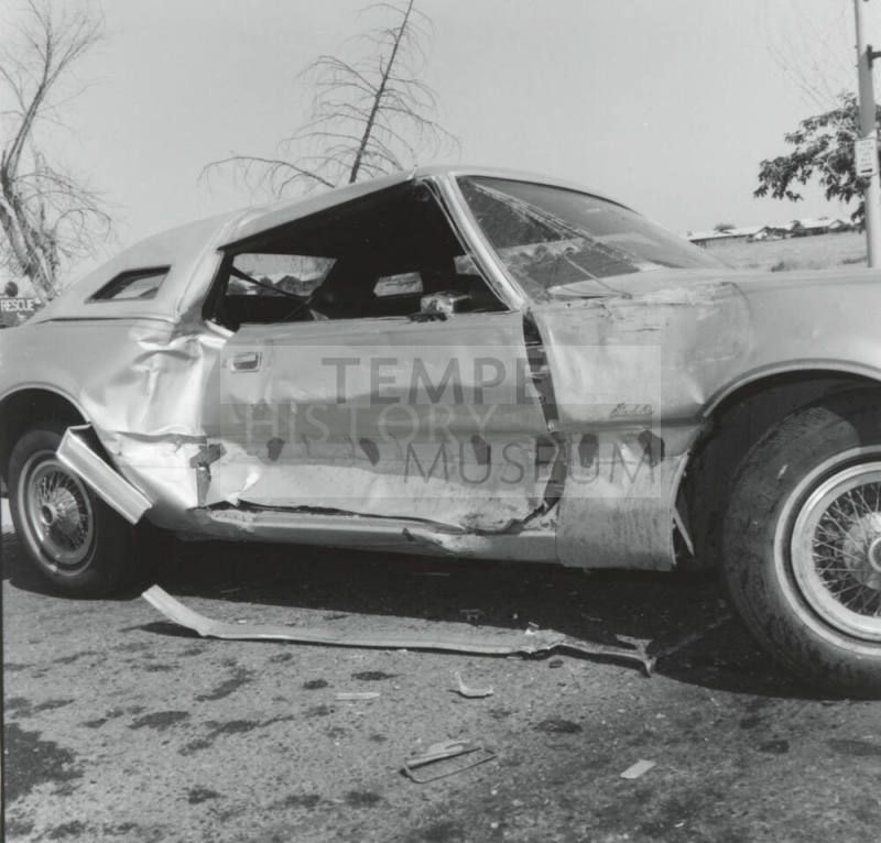 Wrecked Car on Rural Road, with passenger side damage.