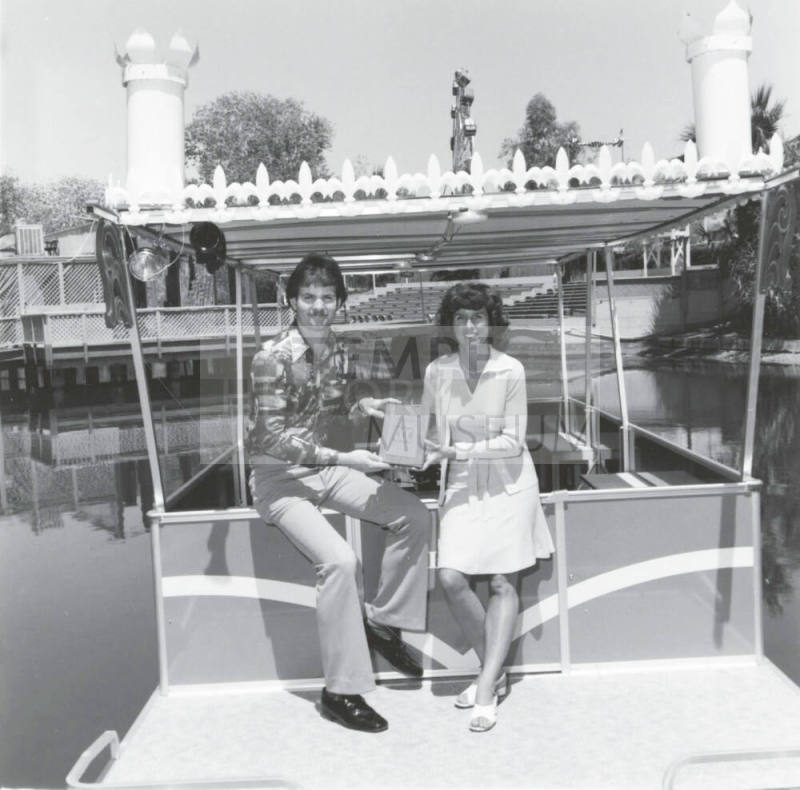 A Couple Displays a Plaque at Legend City