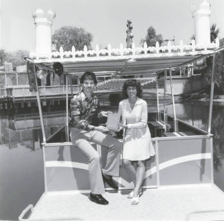 A Couple Displays a Plaque at Legend City