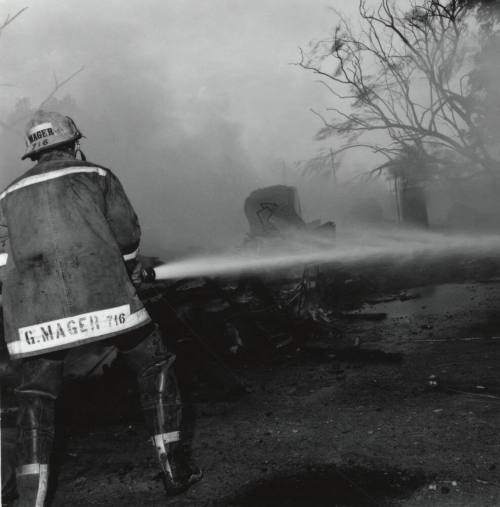 Firefighter and hose. - June 9 1977