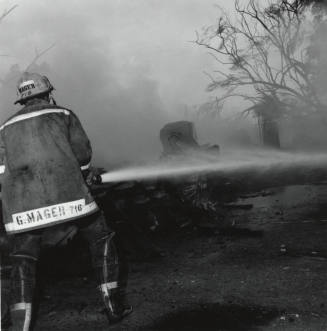 Firefighter and hose. - June 9 1977