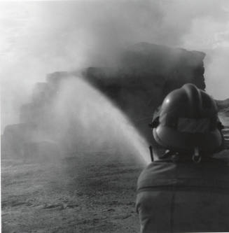 Firefighter Hoses Down a Hay Fire - Tempe Daily News, June 9, 1977