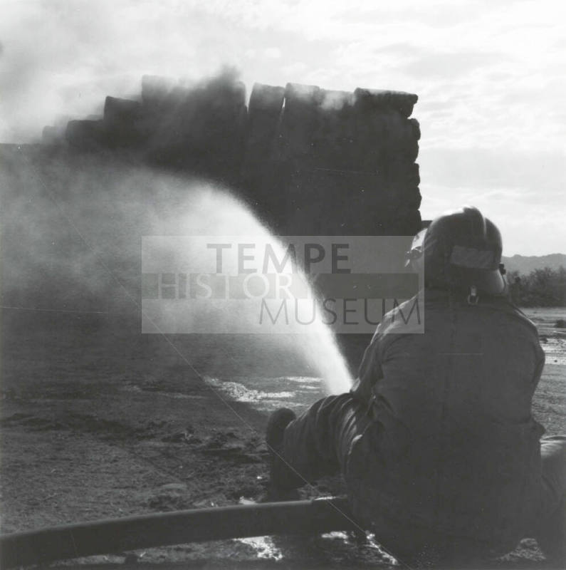 Firefighter Hoses Down a Hay Fire - Tempe Daily News, June 9, 1977