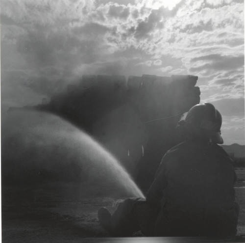 Fireman Hosing Down a Hay Fire - June 9, 1977