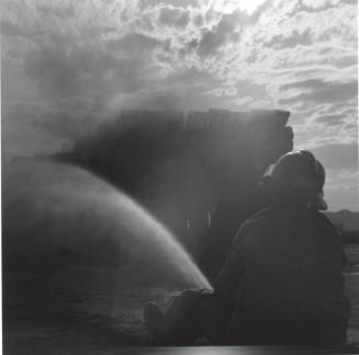 Fireman Hosing Down a Hay Fire - June 9, 1977