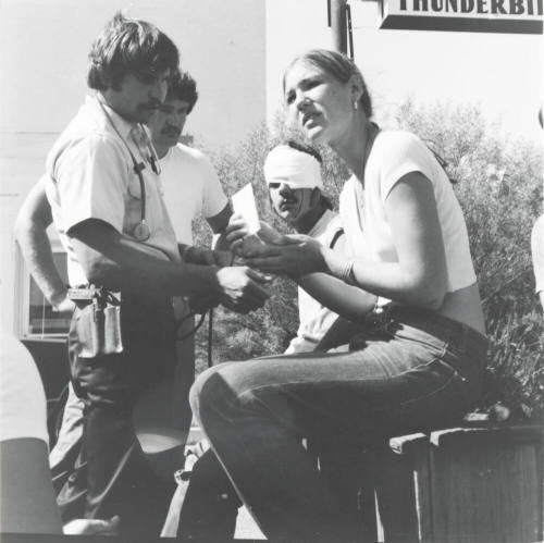 Injured man and woman. - June 1977