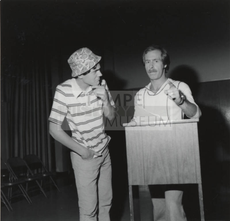Two Men Standing At Podium