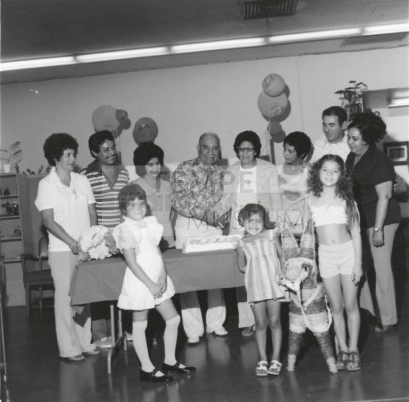 Unidentified Couple Celebrating with Cake & Family - 2 of 3