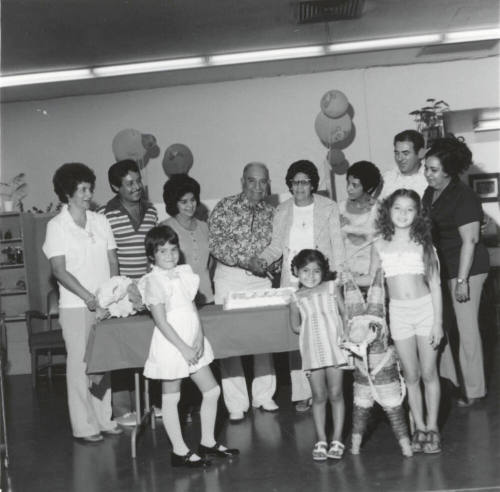 Unidentified Couple Celebrating with Cake & Family - 2 of 3