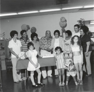 Unidentified Couple Celebrating with Cake & Family - 2 of 3