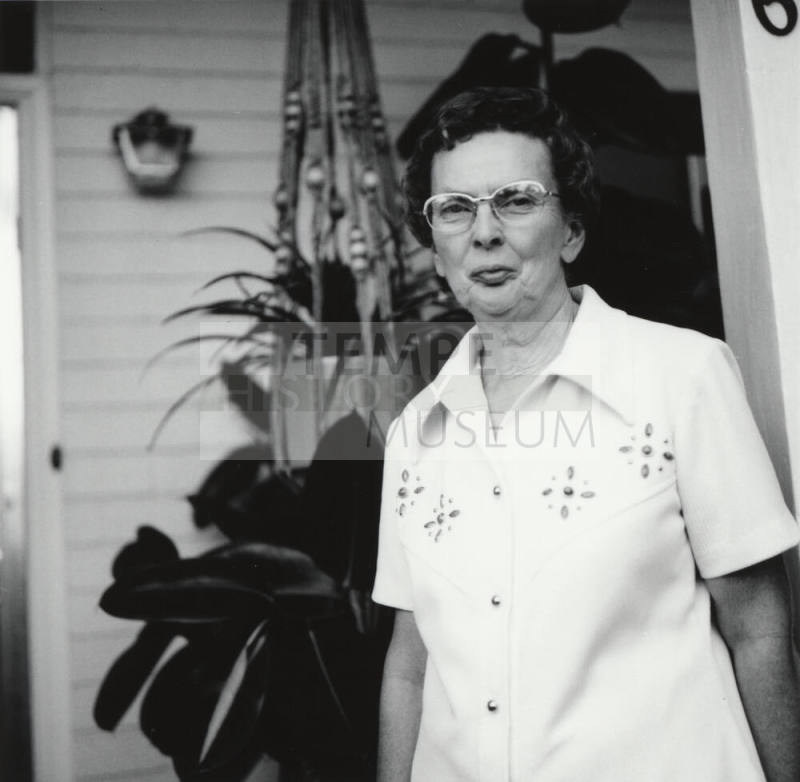 Unidentified Woman Standing On Porch
