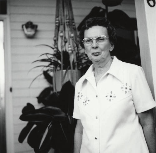 Unidentified Woman Standing On Porch